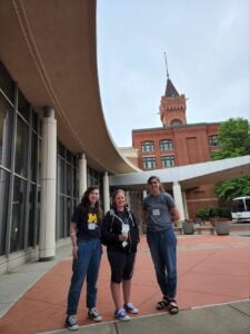 Alex, Jen, and Lauren in front of the conference building
